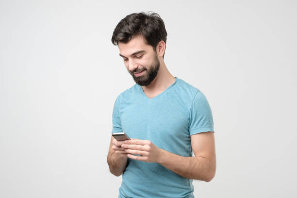 istock Young hispanic man speaking on the phone and smiling while looking on screen. 1210930759