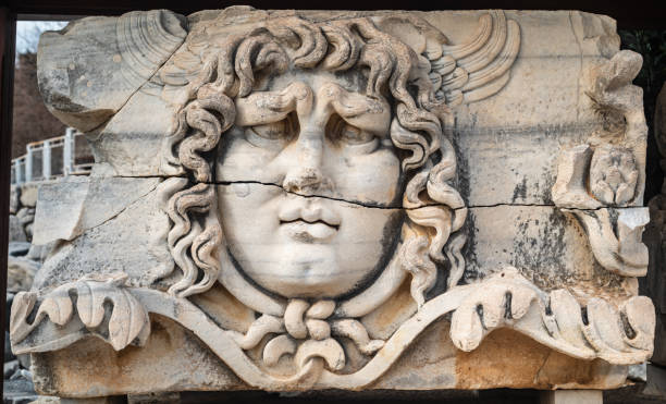 the symbol of the temple of apollo is the head of medusa carved into marble. - mythology marble close up architecture imagens e fotografias de stock