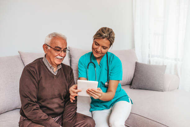istock Nurse showing digital tablet to a patient. 1210931698
