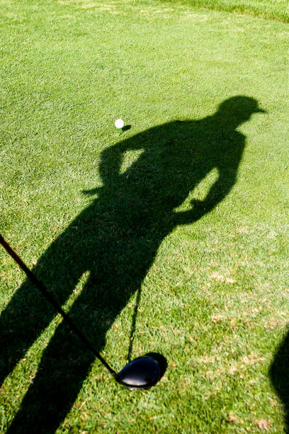 istock Shadow of a golf player on the grass 1210934771