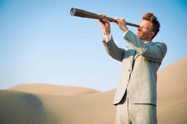 istock Businessman Looking Through Telescope Outdoors 1210934797
