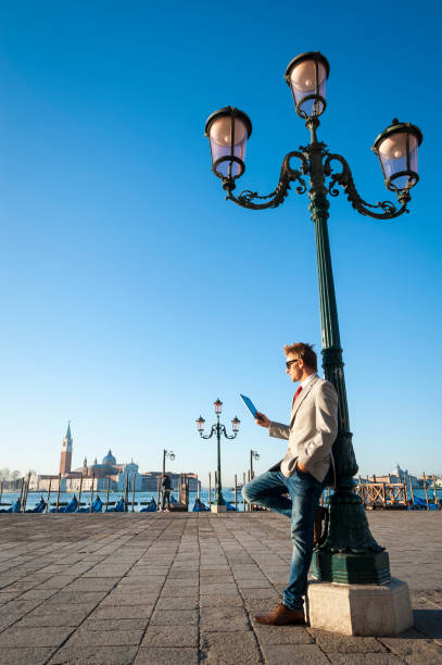 fashionable european man outdoors with tablet venice - travel outdoors tourist venice italy imagens e fotografias de stock