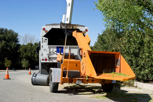 Wood Chipper being used in a residential neighborhood.