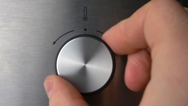 Adjusting Electric Oven Temperature by Turning the Oven Switch Close Up
