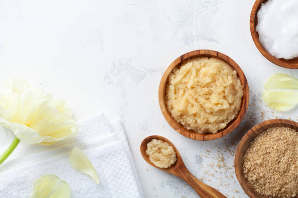 istock Sugar body scrub with ingredients on white stone table. Homemade cosmetic for spa. 1210941015