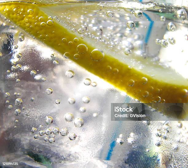 Macro View Of Fresh Lemon Infused Water With Straw Stock Photo - Download Image Now - Backgrounds, Bubble, Citrus Fruit