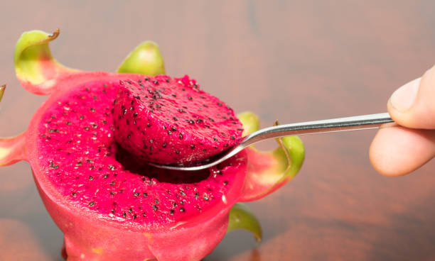 istock delicious dragon fruit in a cut and completely red and white 1210943809