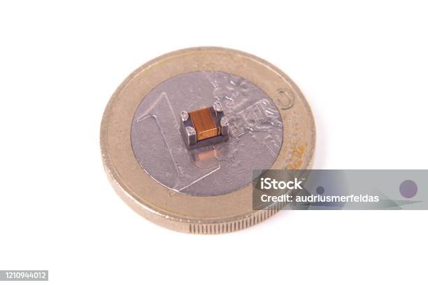 Tiny Common Mode Choke Filter In Comparison With 1 Euro Coin Stock Photo - Download Image Now