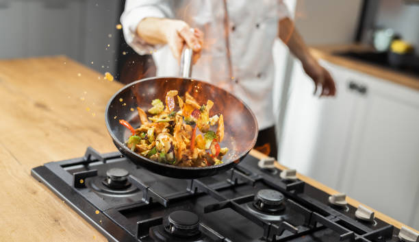 istock Professional Chef Tossing Food 1210947137