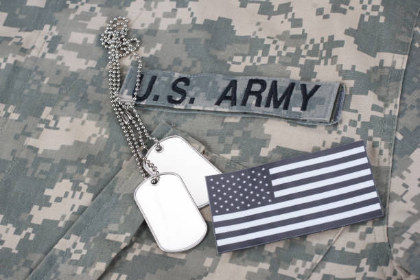 istock US flag patch with dog tag on Army Combat Uniform 1210948387
