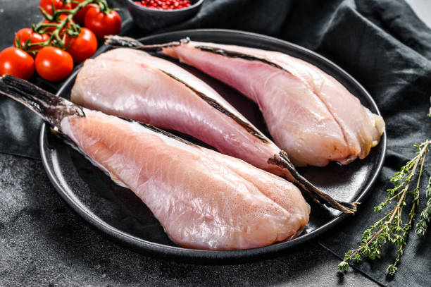 separate raw fish monkfish. black background. top view - anglerfish imagens e fotografias de stock