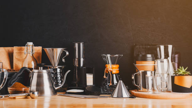 istock Accessories and utensils for making coffee drinks on a wooden table, coffee shop interior 1210950827