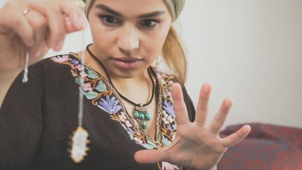 istock mystic woman with divine magic powers chanting. Authentic fortune teller using crystal. Occultism and paranormal activity concept. 1210951080