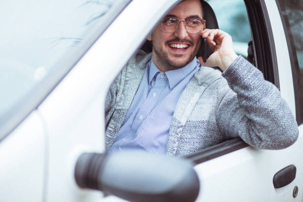 istock Young man in car driving 1210952132