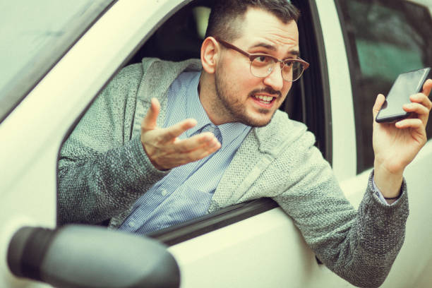 istock Young man in car driving 1210952134
