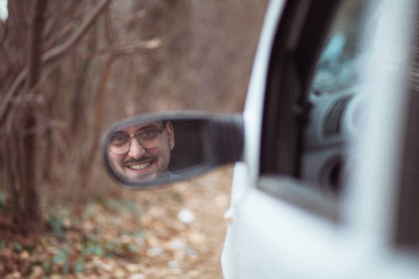 istock Young man in car driving 1210952162