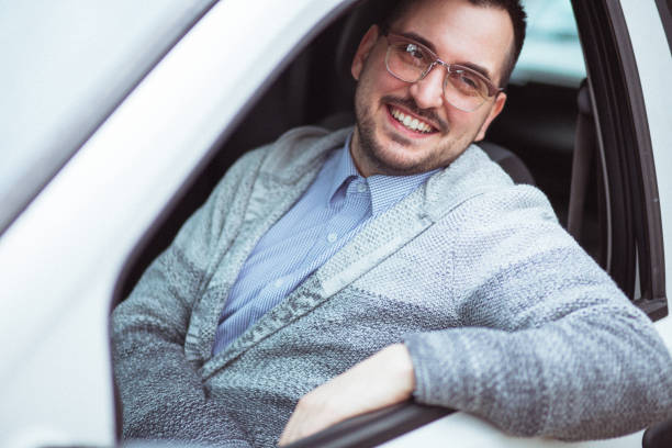 istock Young man in car driving 1210952231