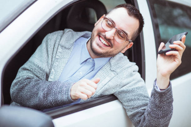 istock Young man in car driving 1210952259