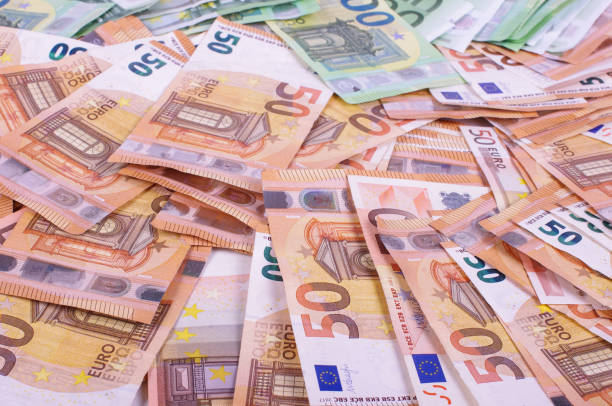 istock Many euro banknotes spread all over 1210952334