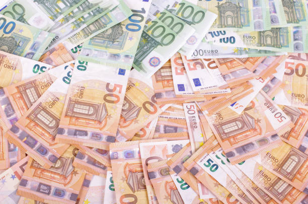 istock Many euro banknotes spread all over 1210952442