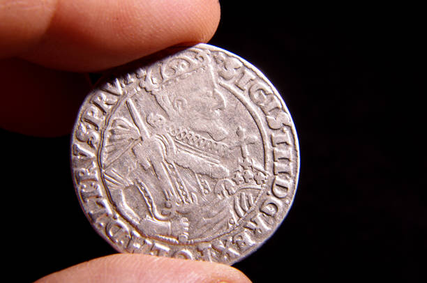 istock Male hand holding old silver MDL place coin (1/4 thaler) 1210953025
