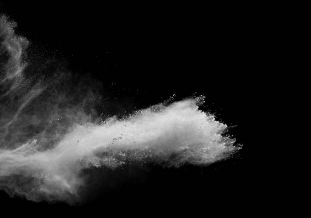 White powder explosion cloud against black background.White dust particles splash.