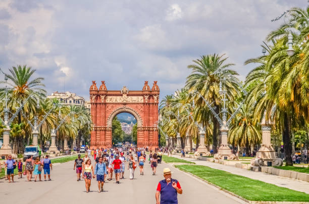 Promenade Passeig de Lluis Companys and the Arc de Triomf - a triumphal arch in the city of Barcelona in Catalonia, Spain. Barcelona/Spain - 17.08.2018: Attractions in the center of Barcelona arc de triomf barcelona stock pictures, royalty-free photos & images
