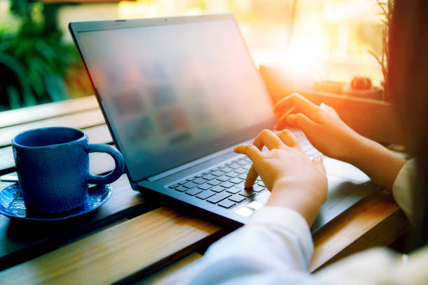 istock woman hand working on computer laptop with coffee cup beside 1210954093