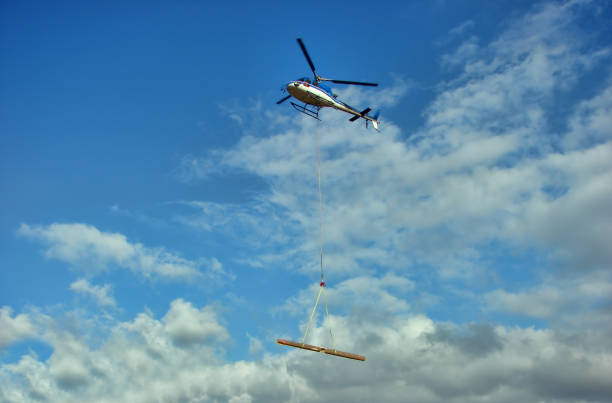 istock Helicopter transports a wood beam 1210955297