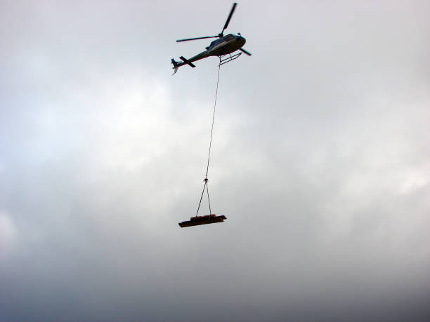 istock Helicopter transport a wood beam 1210955405