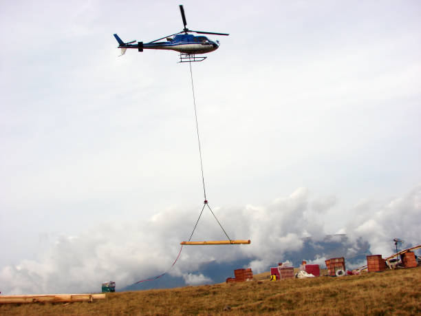 istock Helicopter transport a wood beam 1210955428