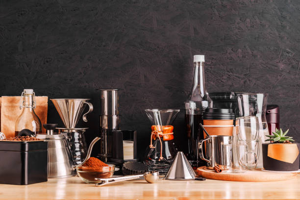 istock Accessories and utensils for making coffee drinks on a wooden table, coffee shop interior 1210956978