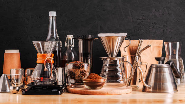 istock Accessories and utensils for making coffee drinks on a wooden table, coffee shop interior 1210958173