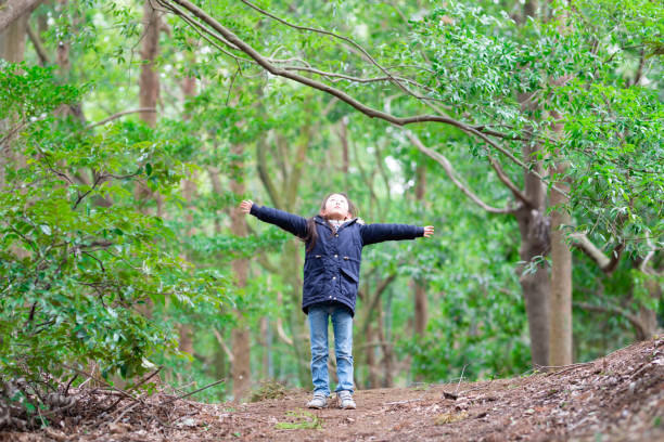 istock Girl taking a deep breath in the woods 1210958293