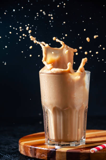 istock Iced Coffee with Splash in Tall Glass on Dark Background. Concept Refreshing Summer Drink 1210960347