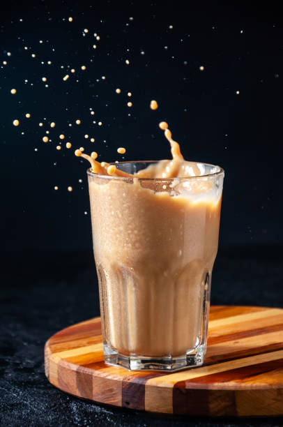 istock Iced Coffee with Splash in Tall Glass on Dark Background. Concept Refreshing Summer Drink 1210960381