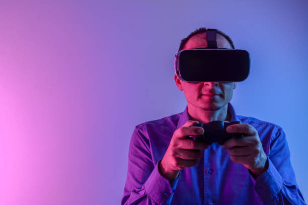 istock Handsome man enjoying games and vr with neon light. 1210961747