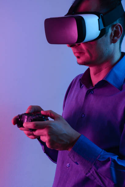 istock Handsome man enjoying games and vr with neon light. 1210961956
