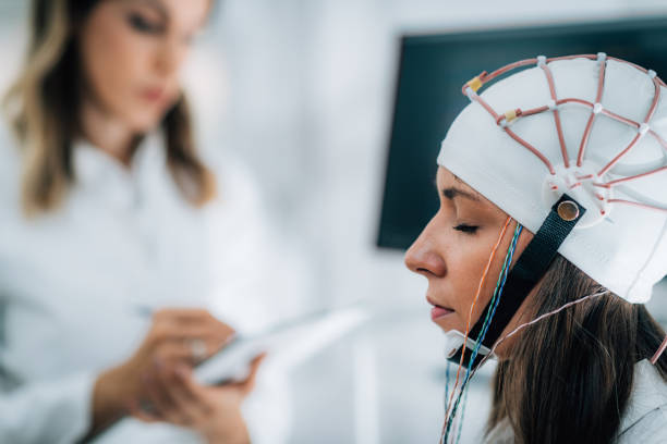 istock Doctor and Patient in Neuroscience Lab, Doing EEG Scan 1210967316