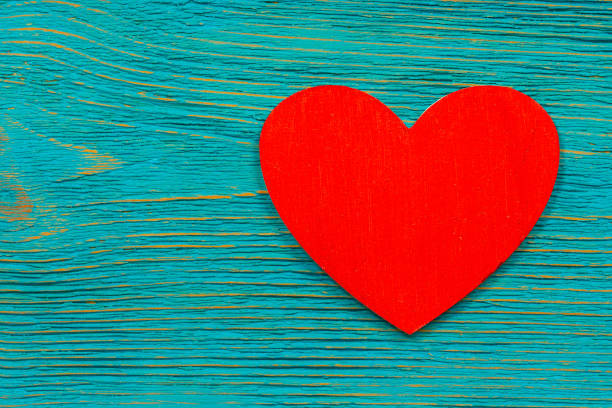 istock red wooden heart shape on turquoise rustic planks 1210967959