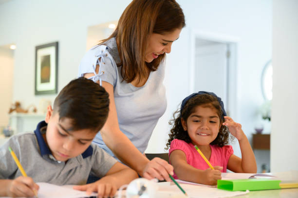 istock Lighthearted Hispanic mother helping children with homework 1210968556