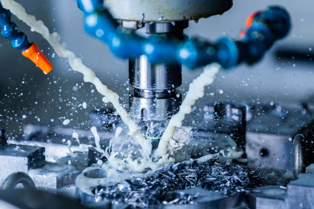 istock a process of vertical cnc steel milling with external water coolant streams, splashes and a lot of metal chips - close-up with selective focus 1210969448