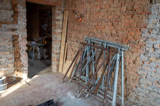 istock on a building site, 2 scaffolding trestles lean against a brick wall 1210970032