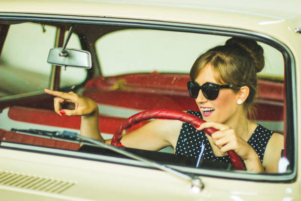 istock Woman driving retro car 1210970394