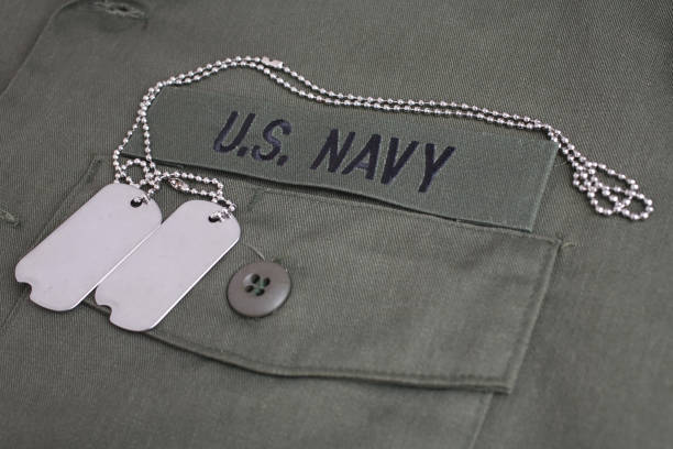 istock U.S. Navy Branch Tape with dog tags on olive green uniform 1210970477