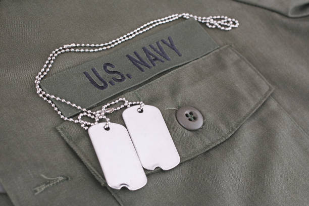 istock U.S. Navy Branch Tape with dog tags on olive green uniform 1210970658