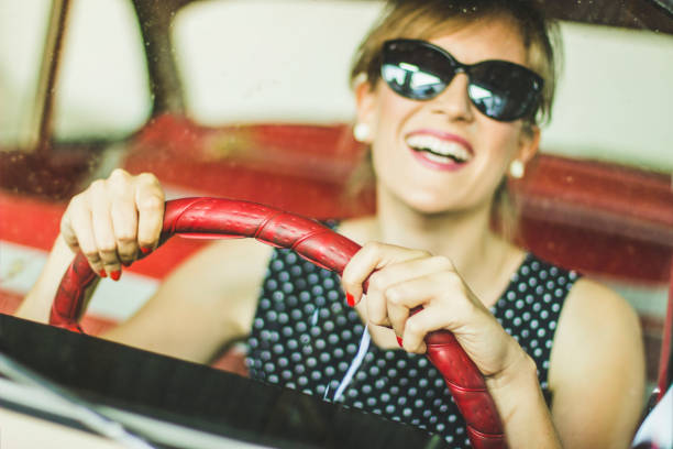 istock Happy woman driving car 1210971708