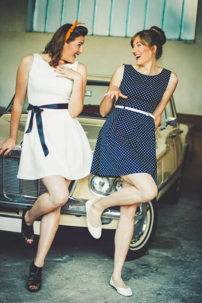 istock Pin up sisters and vintage car 1210972096