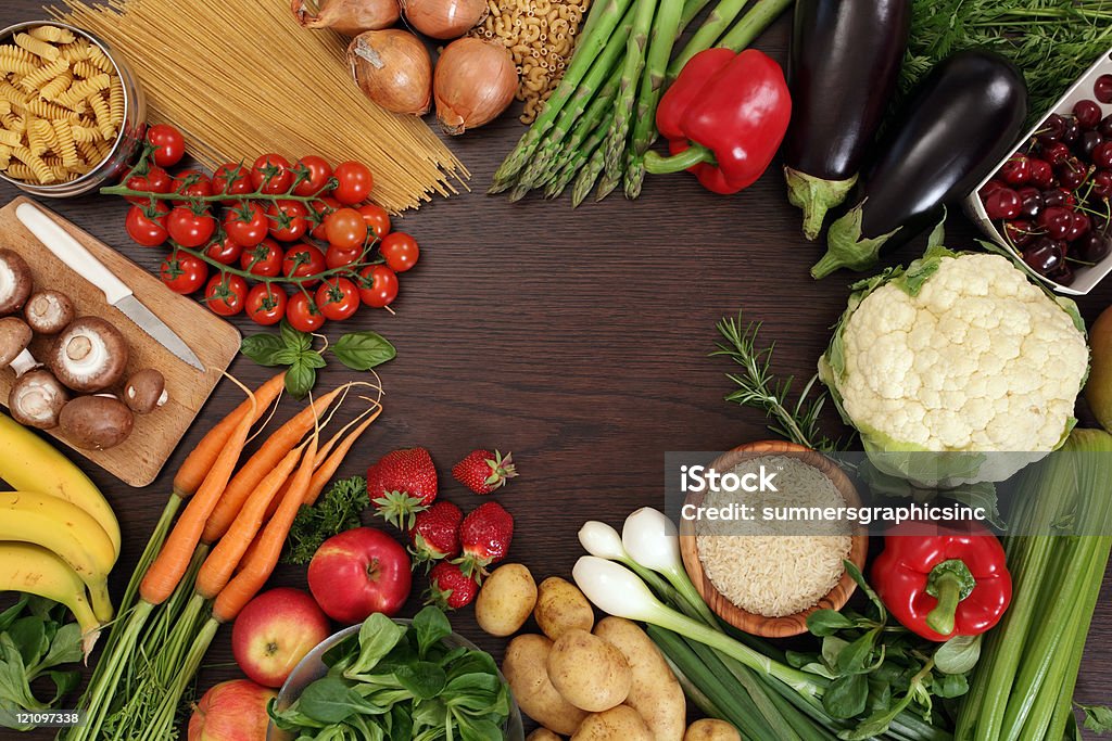 Healthy eating frame Photo of a table top full of fresh vegetables, fruit, and other healthy foods with a space in the middle for text. Edible Mushroom Stock Photo