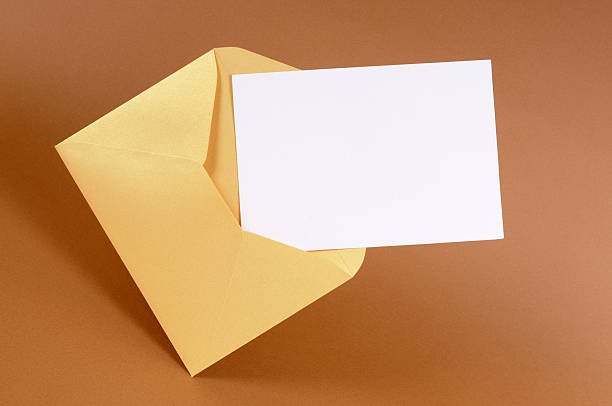 Gold envelope with blank message card Gold envelope with blank message card or invitation (directional lighting is intentional). anniversary card stock pictures, royalty-free photos & images